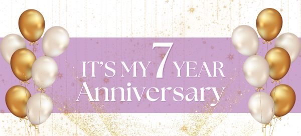 Gold and white balloons frame a pink banner that reads “It’s my 7 year anniversary” on a glittery gold background.
