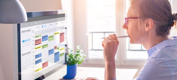 Person reviewing content performance metrics on a computer screen, planning PR activity and analysing results for blogs, reports and white papers