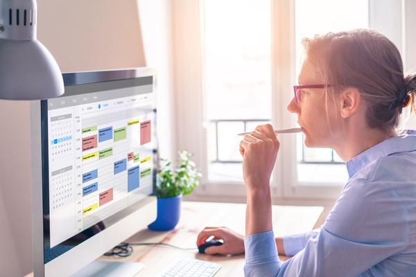 Person reviewing content performance metrics on a computer screen, planning PR activity and analysing results for blogs, reports and white papers