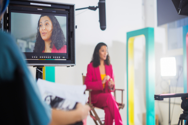 Business spokesperson taking part in a filmed media interview for news and media coverage