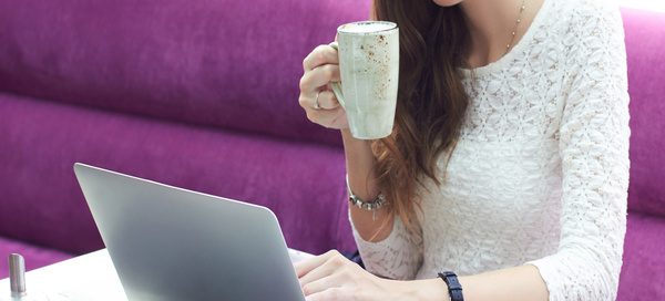 Business owner reviewing content marketing and research report plans on a laptop while working remotely